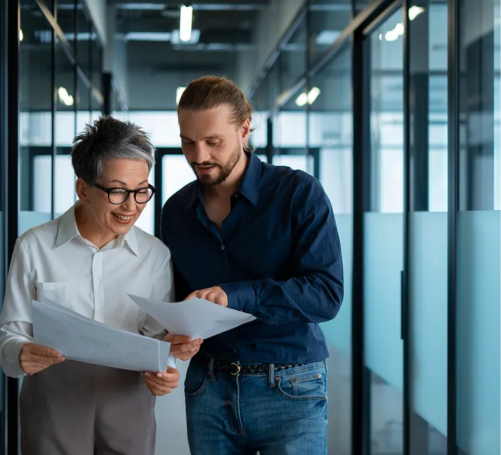 Two colleagues looking over a document together